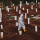 A municipal cemetery worker walks through a special cemetery for suspected covid-19 victims on September 11, 2020 in Jakarta, Indonesia